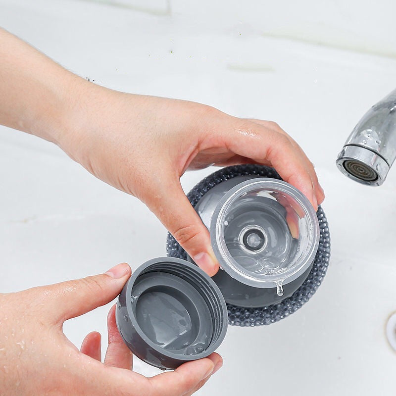 Soap Dispensing Palm Brush in hand
